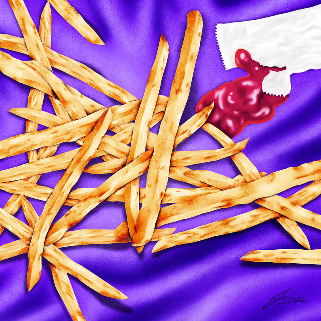 A pile of french fries lies atop a silky satin sheet. A packet of ketchup is ripped open and available for dipping.